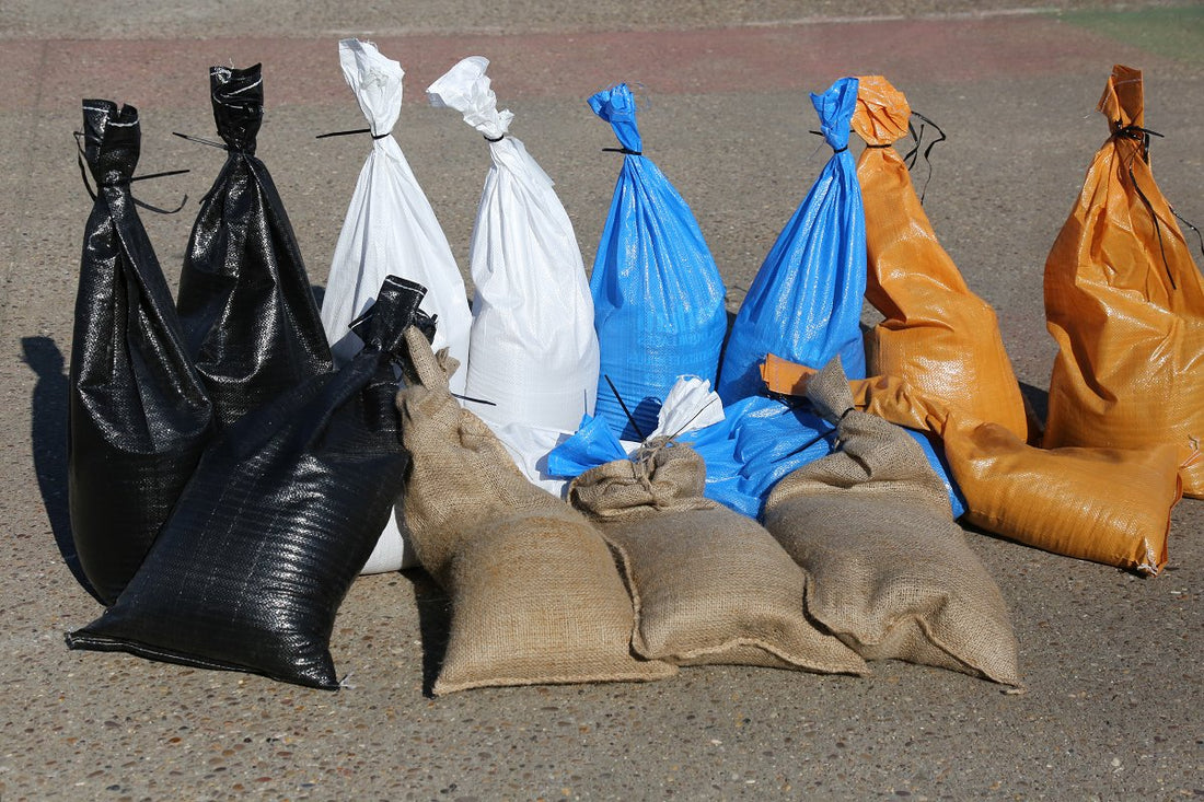 An image of sandbags, filled and with different materials and colours