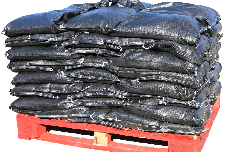 A red pallet of black sandbags