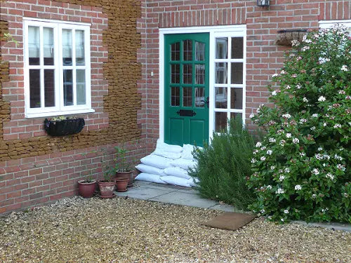 an image of sandbags laid across a doorway to protect from flooding.