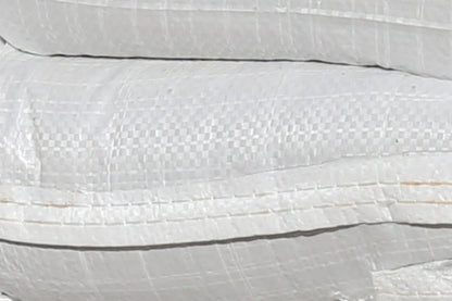 A close up of white woven polypropylene sandbags