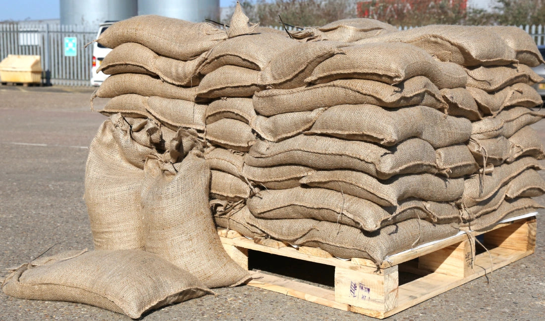 A grounded pallet of hessian jute sandbags